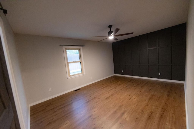 912 Armstrong Ave, West Plains, MO 65775 - spare room featuring baseboards, wood finished floors, visible vents, and ceiling fan