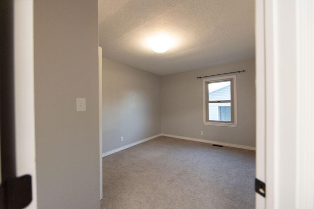 912 Armstrong Ave, West Plains, MO 65775 - carpeted empty room with baseboards, a textured ceiling, and visible vents