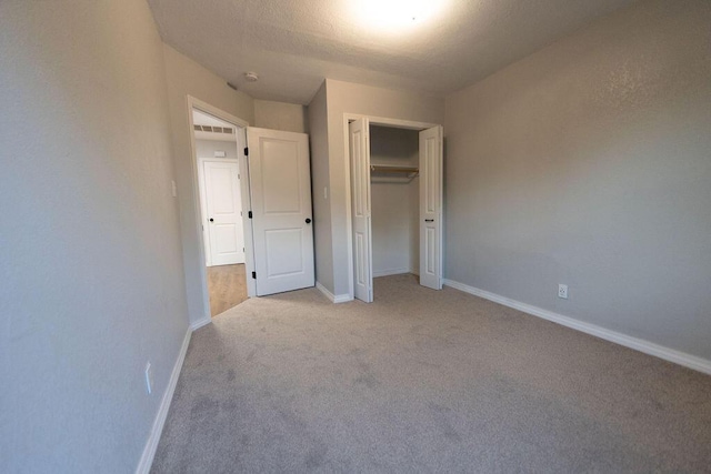 912 Armstrong Ave, West Plains, MO 65775 - unfurnished bedroom with baseboards, a closet, and light colored carpet