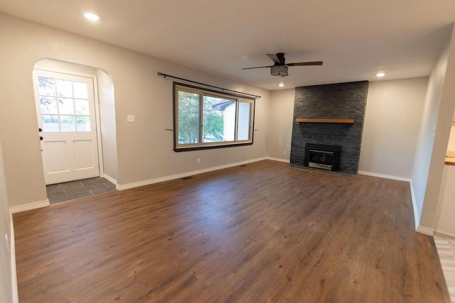 912 Armstrong Ave, West Plains, MO 65775 - unfurnished living room featuring a ceiling fan, dark wood-style flooring, and a healthy amount of sunlight