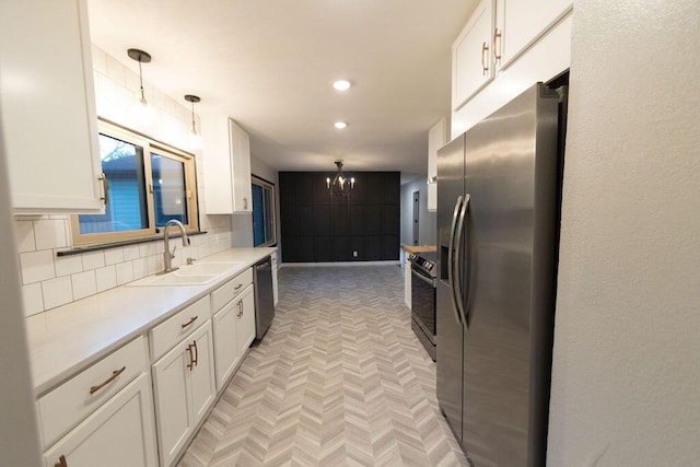 912 Armstrong Ave, West Plains, MO 65775 - kitchen with stainless steel fridge, a sink, a notable chandelier, white cabinetry, and dishwashing machine