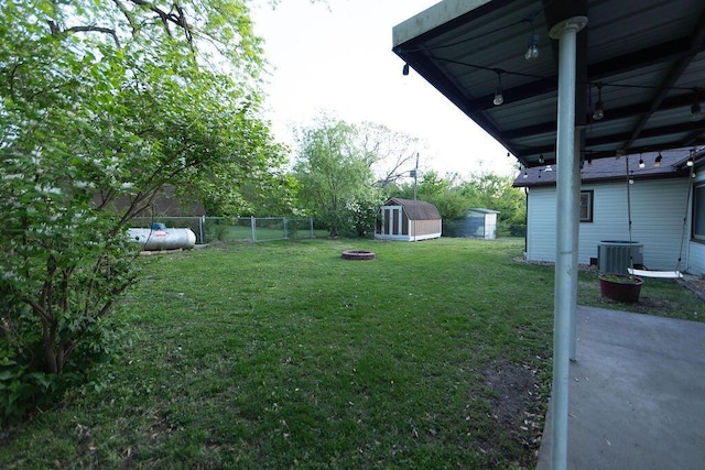 912 Armstrong Ave, West Plains, MO 65775 - view of yard with a fenced backyard, a storage shed, central air condition unit, an outbuilding, and a patio