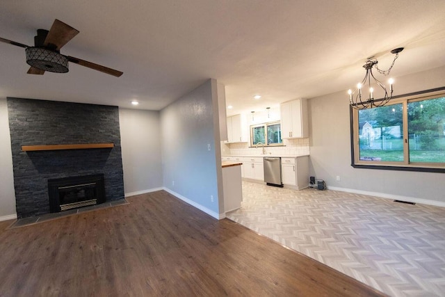 912 Armstrong Ave, West Plains, MO 65775 - unfurnished living room with baseboards, light wood finished floors, visible vents, and ceiling fan with notable chandelier