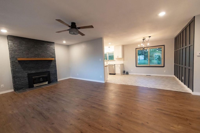 912 Armstrong Ave, West Plains, MO 65775 - unfurnished living room featuring a fireplace, wood finished floors, recessed lighting, and ceiling fan with notable chandelier