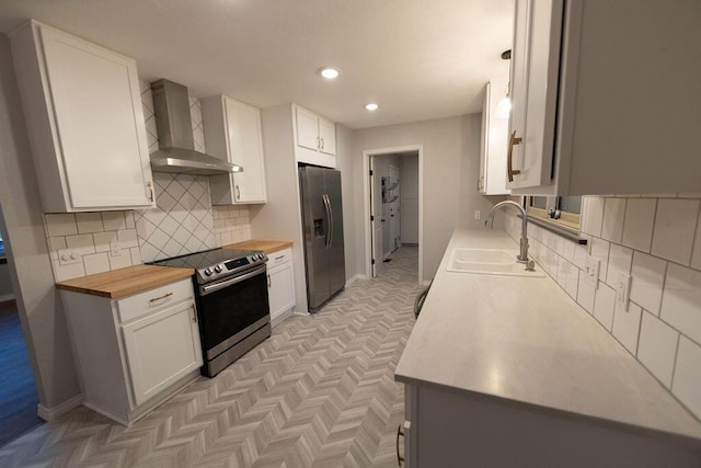 912 Armstrong Ave, West Plains, MO 65775 - kitchen featuring wall chimney range hood, backsplash, stainless steel appliances, and a sink