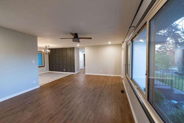 912 Armstrong Ave, West Plains, MO 65775 - spare room featuring ceiling fan with notable chandelier, baseboards, wood finished floors, and visible vents