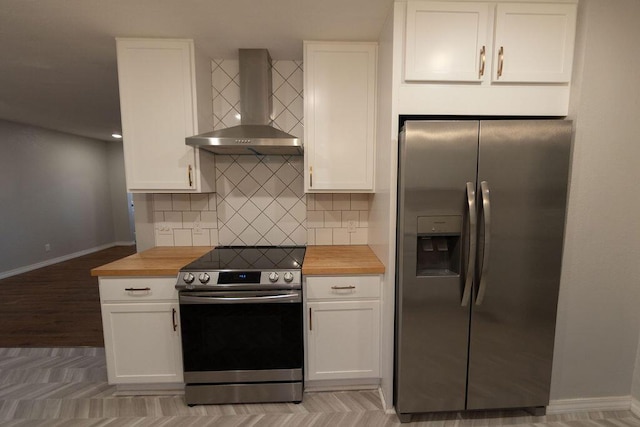 912 Armstrong Ave, West Plains, MO 65775 - kitchen with white cabinets, wall chimney exhaust hood, wooden counters, and stainless steel appliances