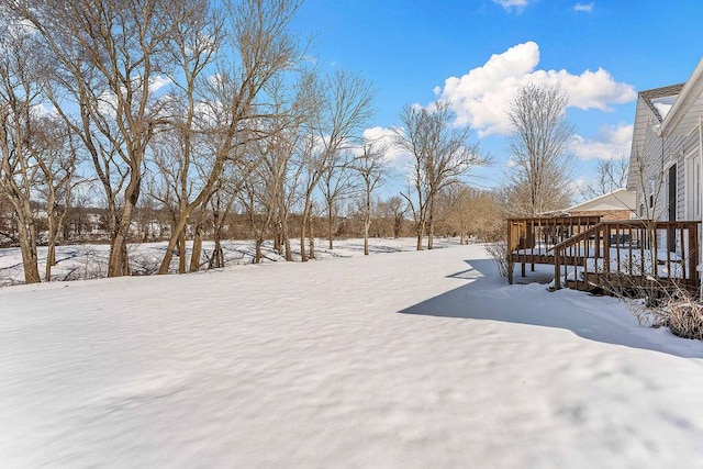 snowy yard with a deck