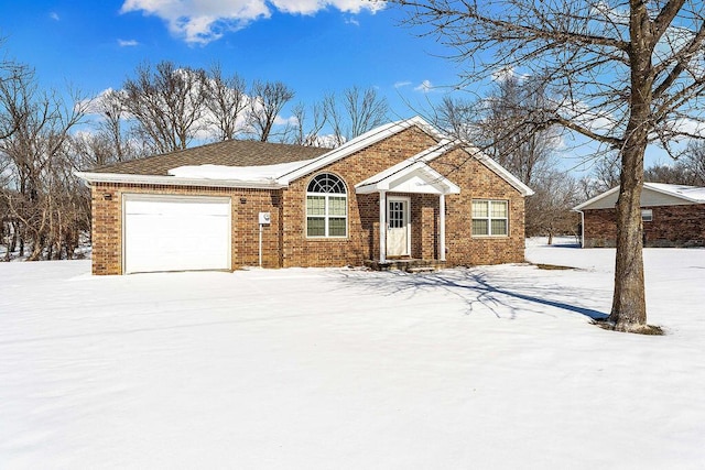 ranch-style home with a garage and brick siding