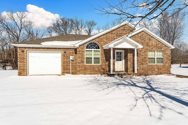 ranch-style house featuring an attached garage and brick siding