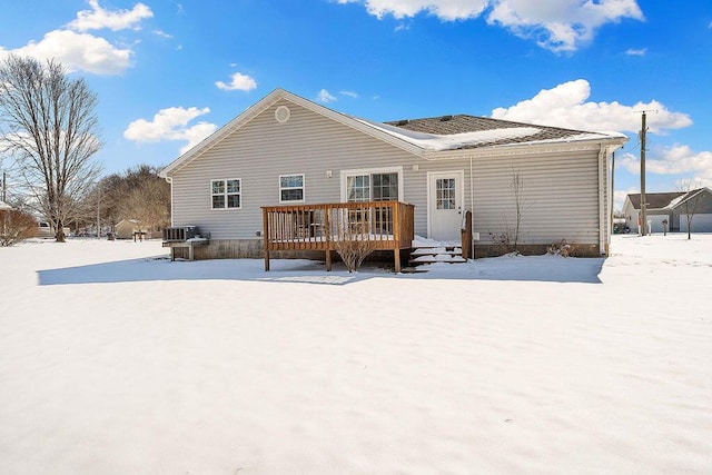 snow covered property featuring central air condition unit and a deck