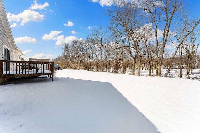 snowy yard with a deck