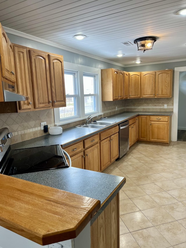 kitchen featuring crown molding, stainless steel appliances, dark countertops, brown cabinetry, and a sink