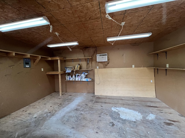 garage with a workshop area and a wall mounted air conditioner