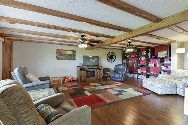 living area featuring dark wood-style floors, a textured ceiling, a fireplace, and a ceiling fan