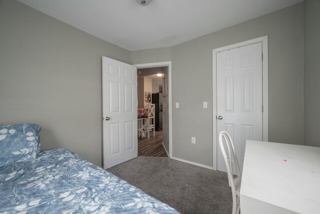 bedroom with baseboards and carpet