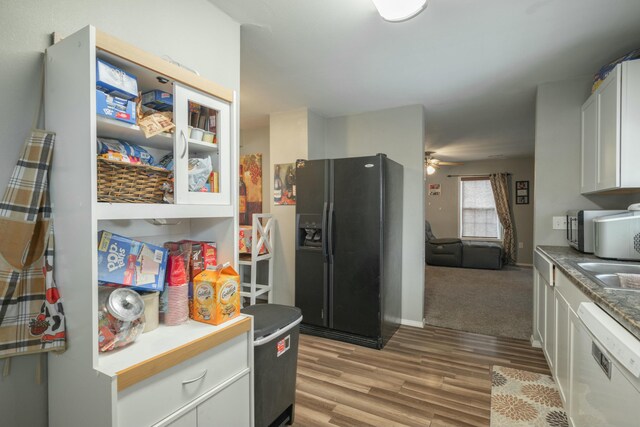 kitchen featuring white cabinetry, light wood-style flooring, ceiling fan, dishwasher, and black refrigerator with ice dispenser