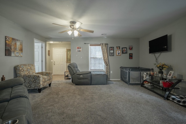 carpeted living area featuring visible vents and a ceiling fan