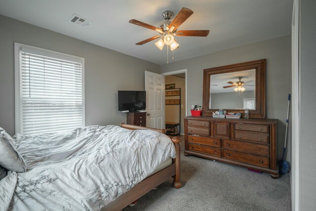 bedroom with carpet flooring, a ceiling fan, and visible vents