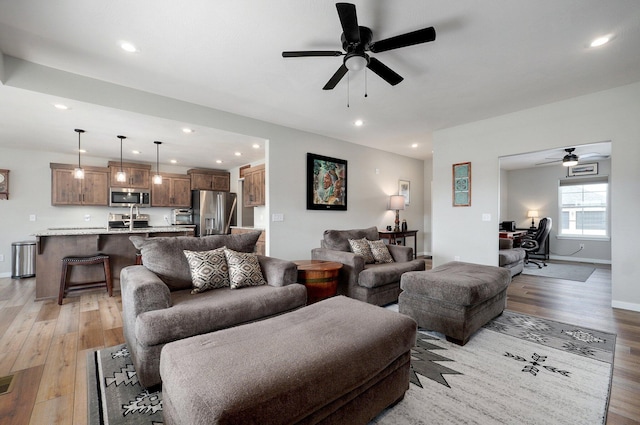 living room featuring light wood finished floors and recessed lighting