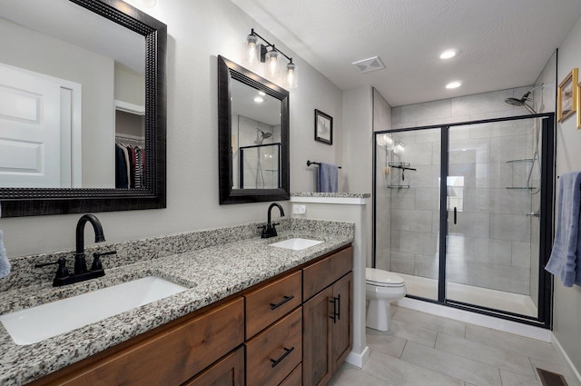 full bath featuring double vanity, a sink, and visible vents