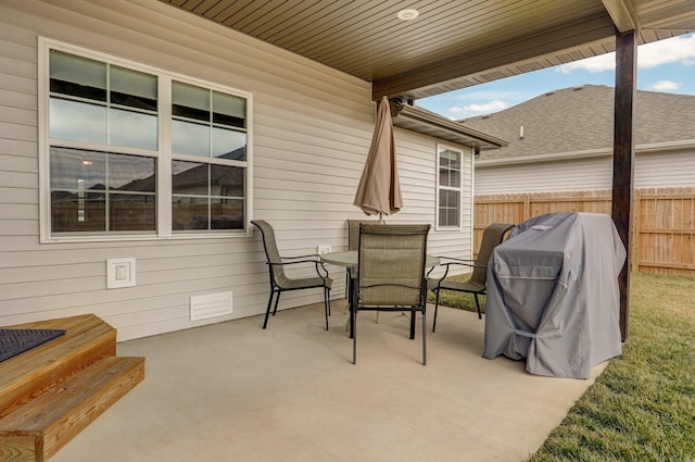 view of patio with outdoor dining space, a grill, and fence