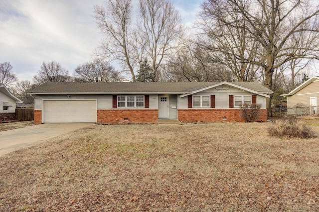 ranch-style house featuring crawl space, brick siding, an attached garage, and concrete driveway