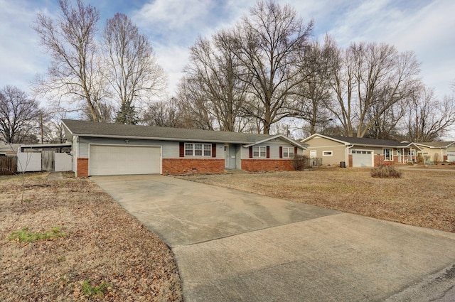 ranch-style house with brick siding, a front yard, crawl space, a garage, and driveway