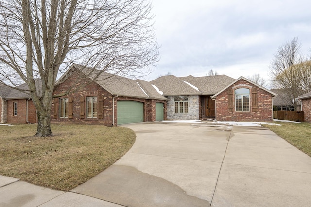 view of front of house featuring brick siding, roof with shingles, concrete driveway, a front yard, and a garage