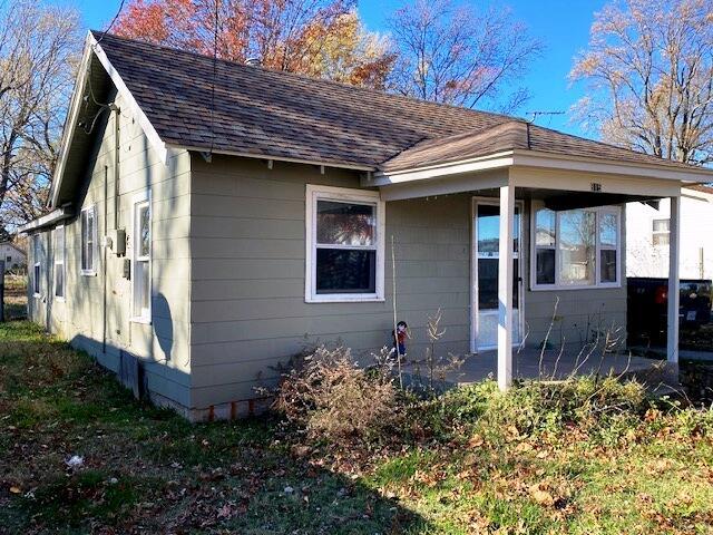 view of side of home featuring a shingled roof