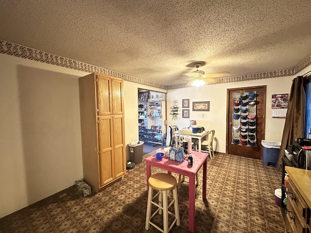 office space with ceiling fan, dark floors, and a textured ceiling