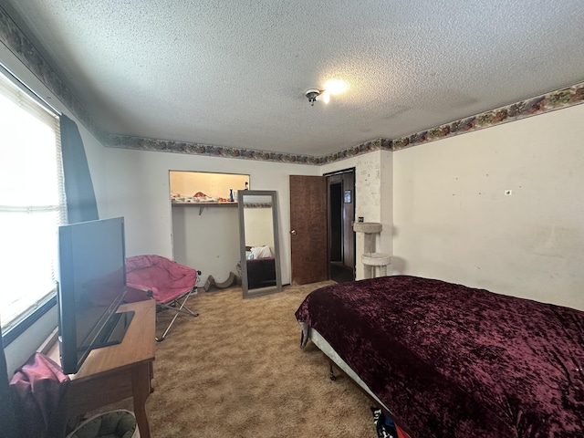 bedroom with carpet flooring and a textured ceiling