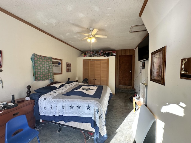 bedroom with ceiling fan, ornamental molding, a textured ceiling, dark carpet, and a closet