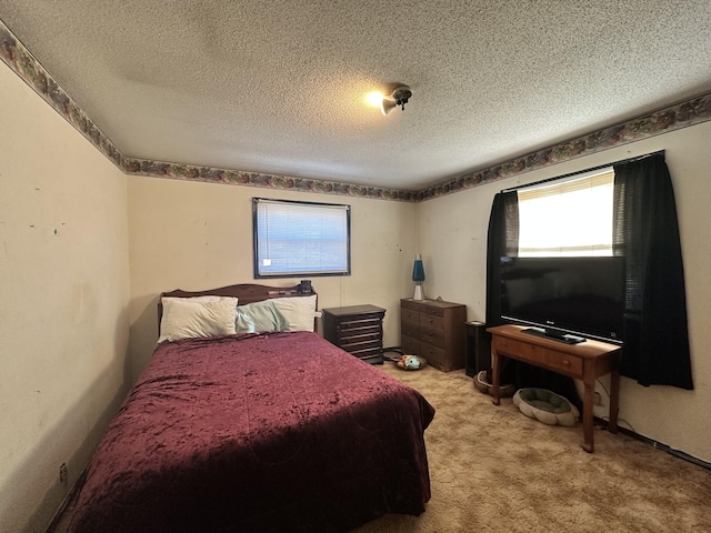 bedroom with a textured ceiling and light colored carpet