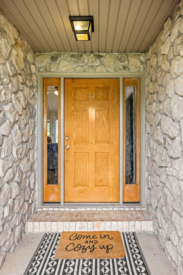 view of exterior entry with stone siding