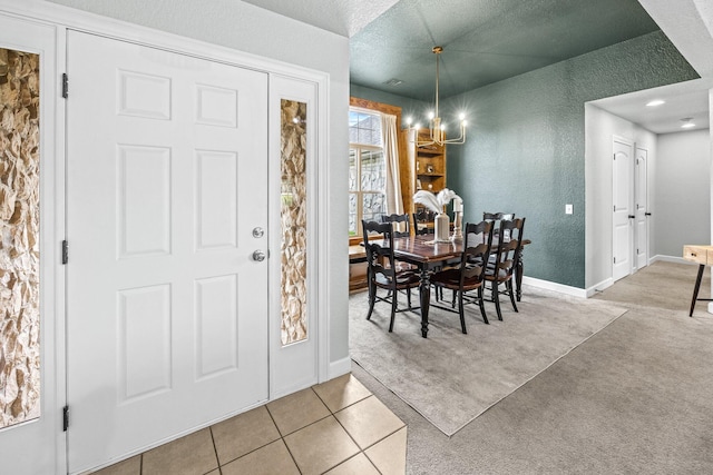 dining space with light tile patterned floors, a textured wall, a textured ceiling, light carpet, and baseboards