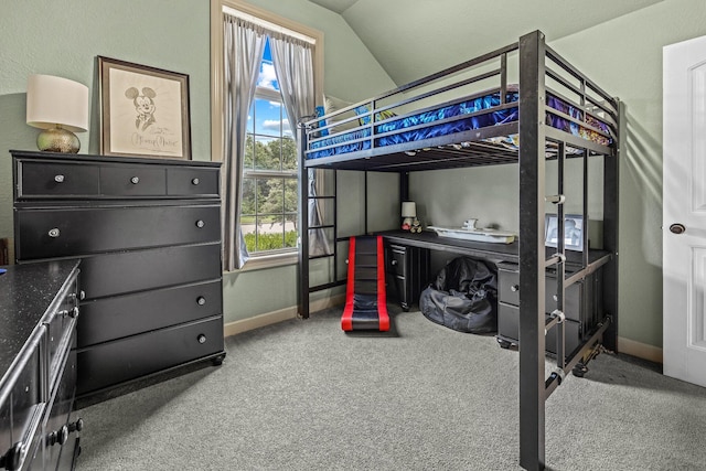 carpeted bedroom featuring vaulted ceiling and baseboards