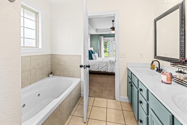 full bath with a sink, a jetted tub, tile patterned floors, double vanity, and ensuite bath