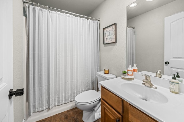 bathroom featuring shower / bathtub combination with curtain, a textured wall, vanity, and toilet