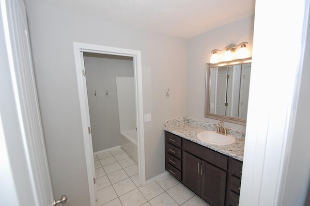 bathroom with baseboards, vanity, and tile patterned floors