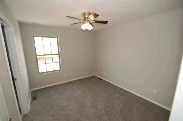 spare room featuring carpet flooring, visible vents, and baseboards