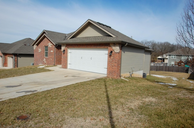 view of front facade with a garage, brick siding, fence, driveway, and a front yard