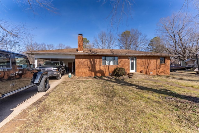 view of front of house featuring brick siding, a chimney, entry steps, a carport, and driveway