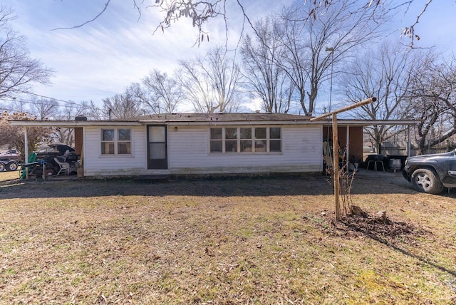 ranch-style home featuring a carport and a front lawn