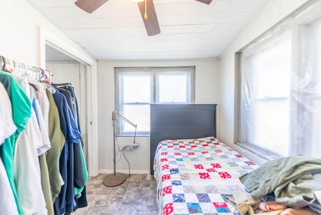 bedroom featuring a closet, ceiling fan, and baseboards