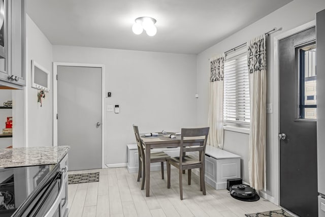 dining room featuring baseboards and light wood-style floors