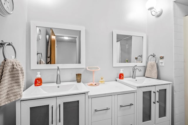 full bathroom featuring two vanities and a sink