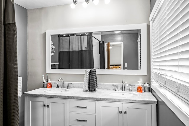 bathroom with double vanity and a sink