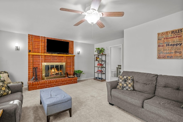 living area featuring carpet flooring, a fireplace, baseboards, and ceiling fan