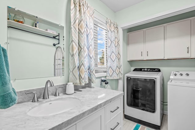 washroom featuring a sink and washer and dryer